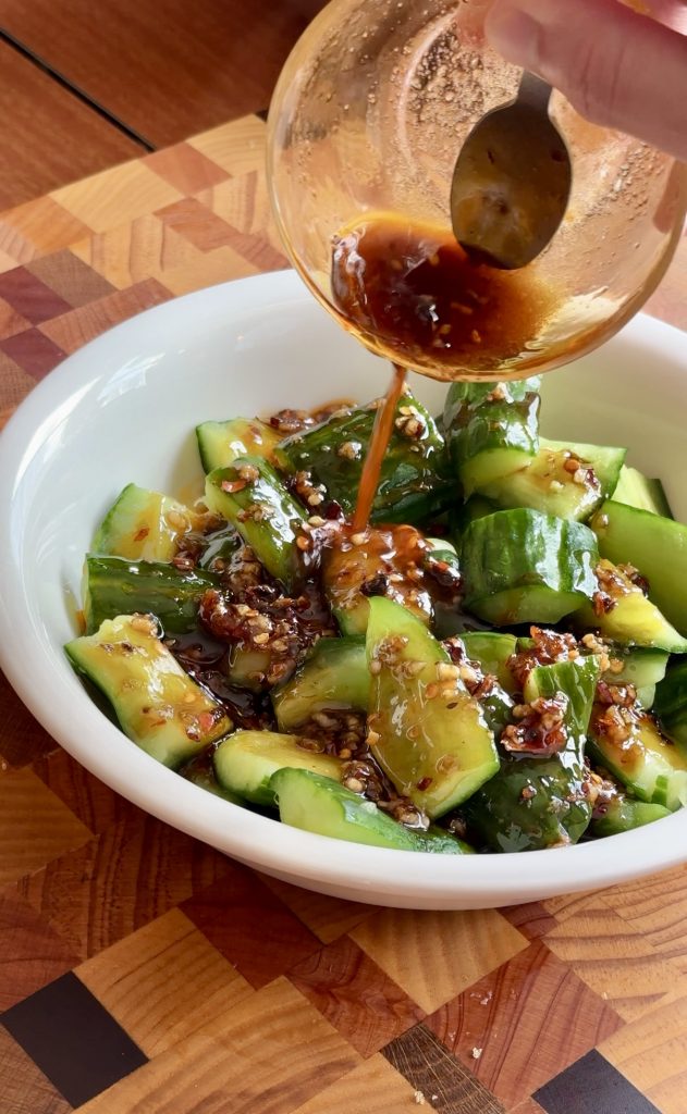 dressing the cucumbers for Chinese cucumber salad