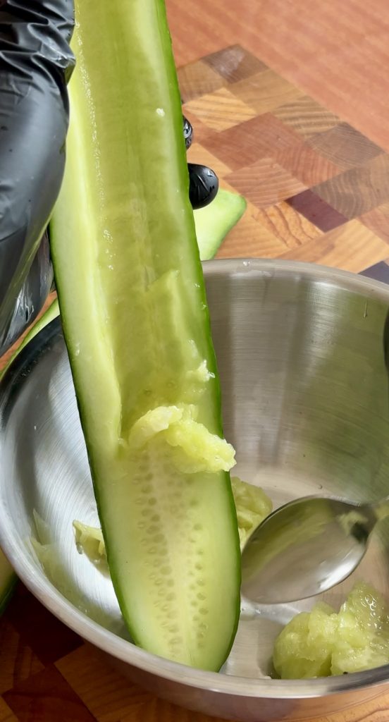 scooping out seeds for Chinese cucumber salad recipe