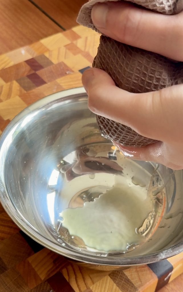 squeezing water from cucumber for Chinese cucumber salad